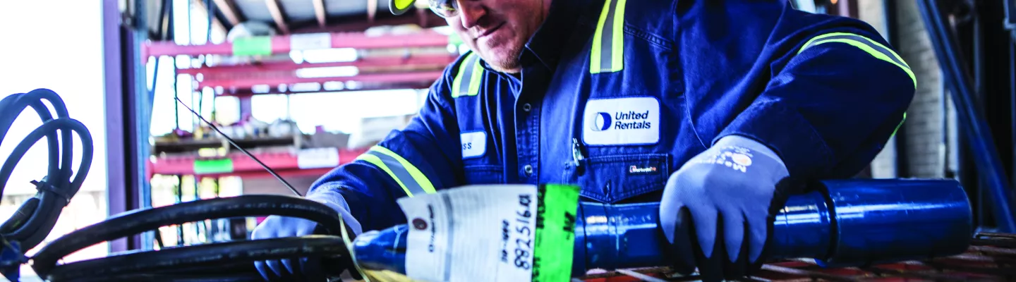 construction worker picking up tool
