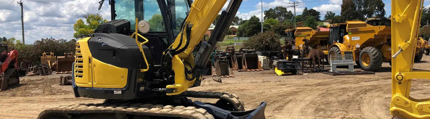Construction equipment positioned on-site, used for installing safety barriers and supporting infrastructure development.
