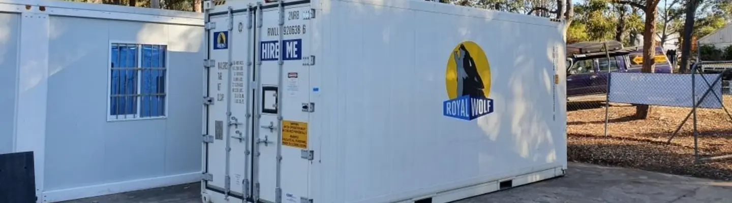  Two container storage units positioned in an open lot, representing modular storage solutions for industrial or commercial use.