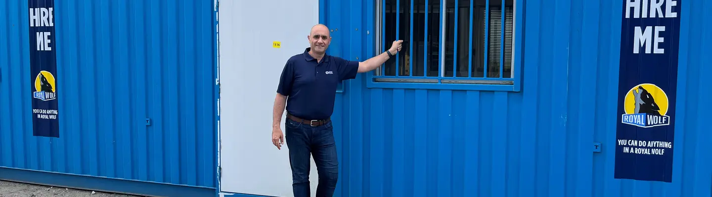 Man standing in front of blue Site Hub shipping container.