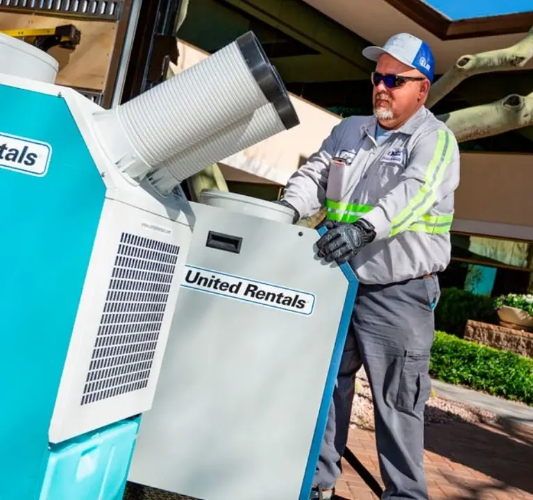 Man installing United Rentals branded temporary AC units.