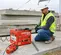 Worker using a Red Multiquip electric rebar bender