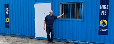 Man standing in front of blue Site Hub shipping container.