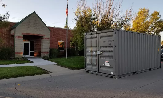 Storage container sitting in front of a building