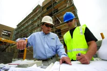 two men in hard hats on construction site