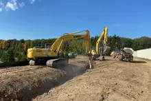 Excavator digging a trench